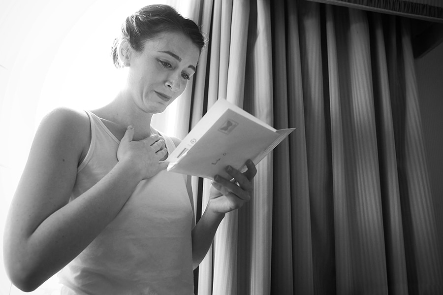 emotional wedding moment when bride reads a note from her groom during the getting ready portion of the day, providence rhode island