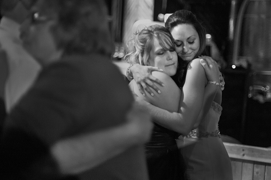 emotional moment between friends during the reception at a wedding held in a vineyard